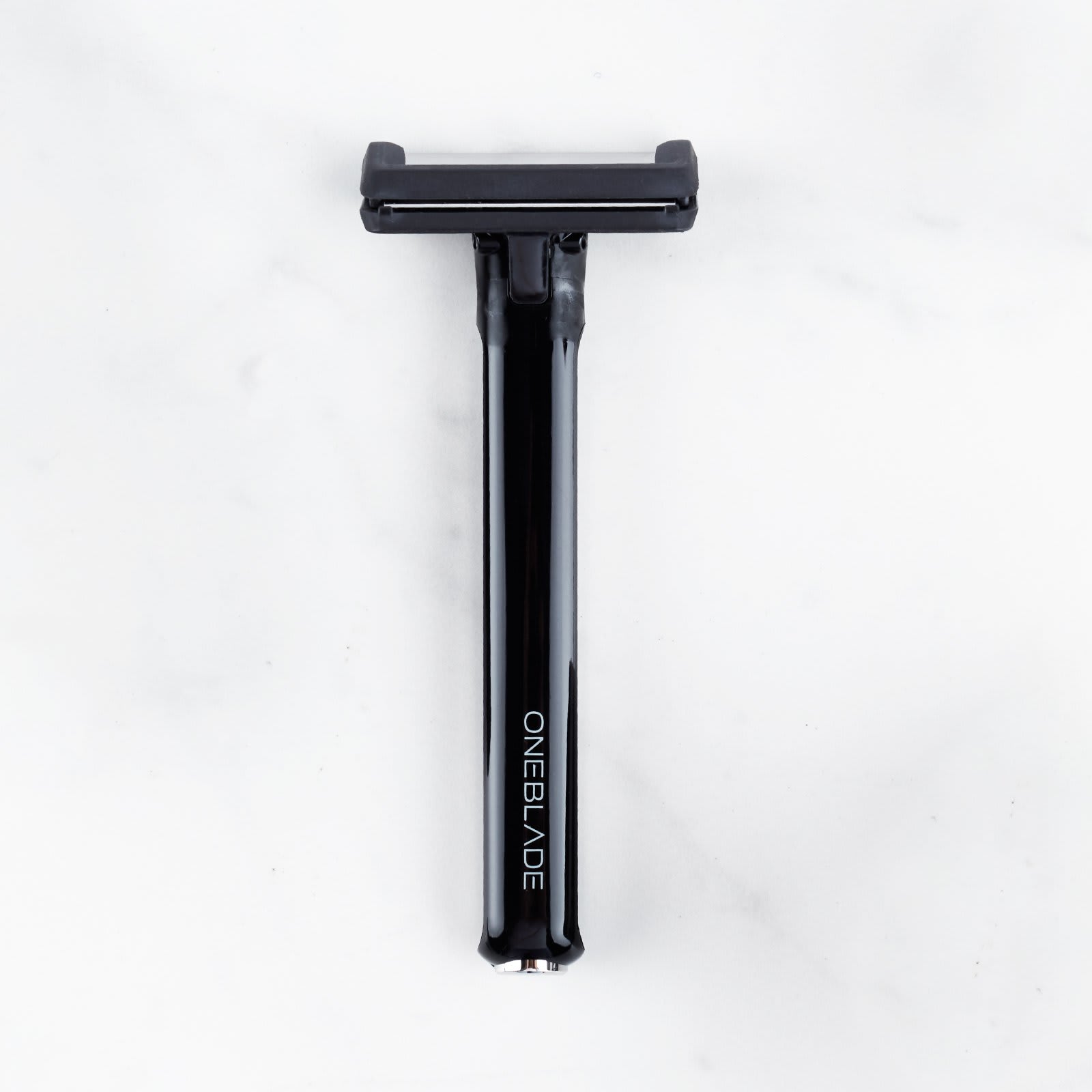 OneBlade Core Single Blade Safety Razor resting on marble surface