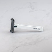 a white Core Safety Razor on a marble background